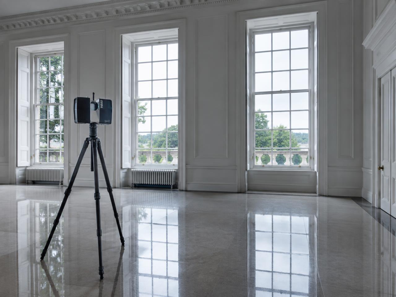 Laser scanner on a tripod inside an empty period room